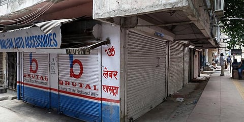 Shops shut down their shutters as the Nai Walan market closed for flouting COVID-19 protocols, in New Delhi on Saturday. (Photo | ANI)