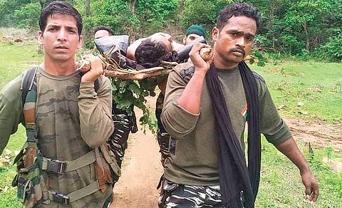 One of the injured jawans being shifted to the helicopter by CRPF personnel. (Photo | Express)