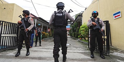 Police officers stand guard at a local police hospital where the bodies of militants killed during a raid were taken to, in Palu, Central Sulawesi, Indonesia, Sunday, July 11, 2021. (Photo | AP)