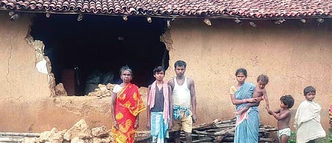 Affected residents in front of their damaged houses in Mahuliasuli village. (Photo | Express)