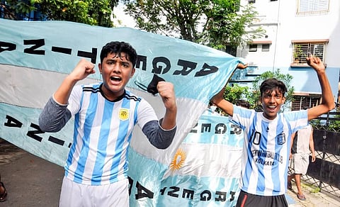 Argentina football fans celebrate with the team flag for their victory over Brazil in the 'Copa America Soccer' final match, in Kolkata. (Photo | PTI)