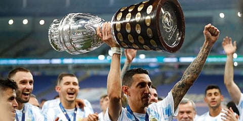 Argentina's Angel Di Maria holds the trophy as he celebrates with teammates after beating 1-0 Brazil in the Copa America final. (Photo | AP)