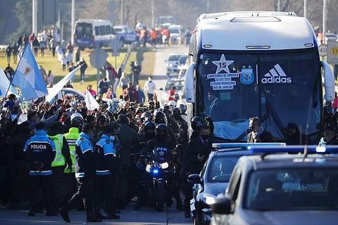 Soccer fans wave flags as the bus driving the national soccer team arrives in Buenos Aires, Argentina, Sunday, July 11, 2021. (Photo | AP)