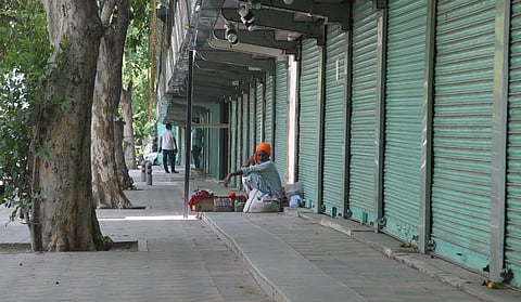 A road side vendor waits for the costumers at closed Janpath Market due to fear of coronavirus. (Photo | Anil Shakya, EPS)
