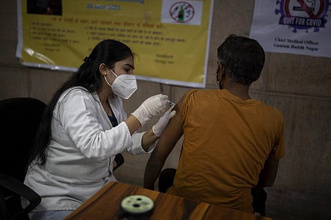 An Indian man receives Covishield vaccine against the coronavirus at a government hospital in Noida, a suburb of New Delhi. (Photo | AP)