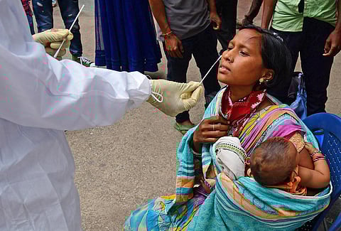 A health worker collects swab samples of a woman in Bengaluru  on Monday | Shriram BN