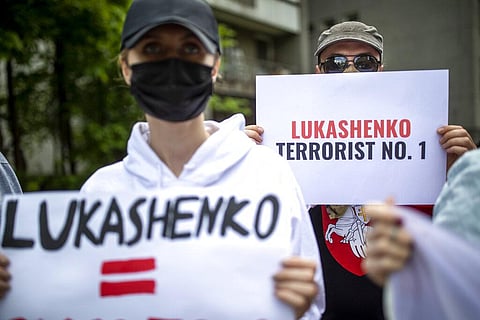 Protesters hold banners during a demonstration demanding freedom for Belarus opposition activist Raman Protasevich, in front of the U.S. Embassy in Vilnius, Lithuania. (File photo | AP)