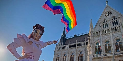 In this file photo dated June. 14, 2021, a drag queen waves a rainbow flag during an LGBT rights demonstration in front of the Hungarian Parliament building in Budapest, Hungary. (File photo | AP)