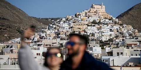 In this file photo from October 4, 2020, people pose for a selfie on the upper deck of a ferry from Athens to the Island of Mykonos, Greece. (File photo | AFP)