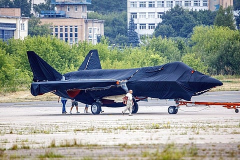 The new warplane hidden under tarpaulin was photographed being towed to a parking spot across the airfield in Zhukovsky outside Moscow. (Photo | AP)