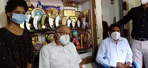 Primary and secondary education minister S Suresh Kumar with Greeshma Nayak N at the latter's residence in Koratagere taluk of Tumakuru district on Saturday (Photo | Special arrangement)