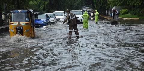 DRF staff controlling traffic near Raj Bhavan in Hyderabad on Sunday evening after rains lashed city. (Photo | R V K Rao, EPS)
