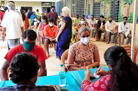 Beneficiaries register themselves to get a dose of COVID-19 vaccine at a vaccination centre, in Bengaluru. (File Photo | ANI)