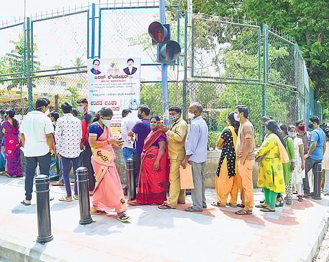 People wait outside a Covid-19 vaccination centre to get inoculated in Bengaluru on Thursday. The city reported 676 fresh cases | shriram bn