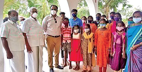 Collector Dr Alby John with Roja, and her students | special arrangement