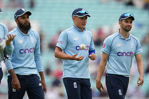 England's Sam Curran, center, throws the ball after taking five wickets as he walks off with his teammates. (Photo | AP)