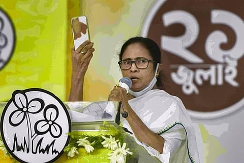 West Bengal CM Mamata Banerjee shows her taped phone while speaking on the Pegasus spyware row during the TMC's Martyrs’s Day event in Kolkata on Wednesday. (Photo | PTI)