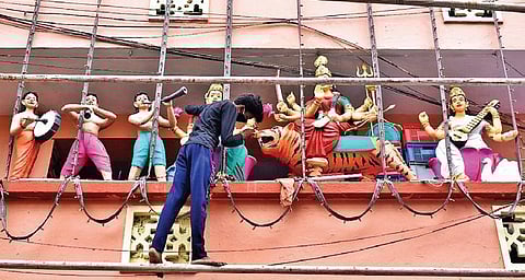 A painter applies finishing touches to the idols at the Ujjaini Mahankali Temple ahead of Bonalu celebrations in Secunderabad on Tuesday (Photo | S Senbagapandiyan, EPS)