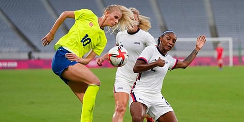 United States' Crystal Dunn, right, and Sweden's Sofia Jakobsson, left, fight for the ball during their soccer match at the 2020 Summer Olympics, Wednesday, July 21, 2021, in Tokyo. (Photo | AP)