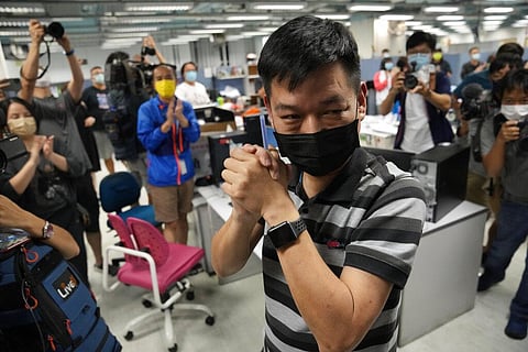 Lam Man-chung, center, executive editor-in-chief of Apple Daily gestures at the headquarters before the newspaper stop publishing in Hong Kong. (Photo | AP)