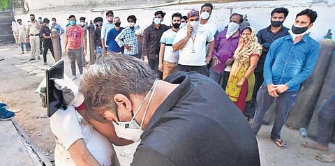 File photo of people waiting to fill oxygen cylinders during the second wave. (File photo | PTI)