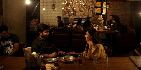 In this representational file photo, a couple shares dinner at Social, a three-story destination on the edge of Hauz Khas Village in Delhi. (File photo | AP)