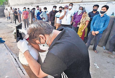 File photo of people waiting to fill oxygen cylinders during the second wave | PTI