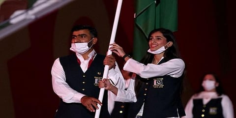 Flag bearers of Pakistan's Olympic team remove their masks during the opening ceremony. (Photo| ANI)