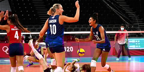 United States' Jordan Thompson (R) celebrates winning a point during the women's volleyball preliminary round pool B match against Argentina at the 2020 Summer Olympics in Tokyo, Japan. (Photo | AP)