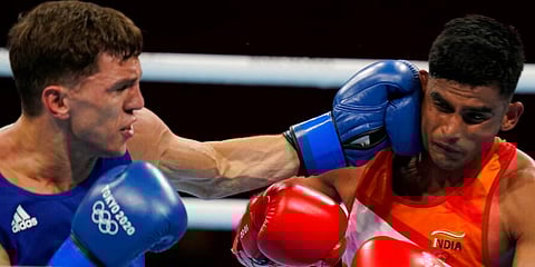 India's Manish Kaushik (R) exchanges punches with Britain's Luke McCormack during their men's lightweight 63-kg boxing match at the 2020 Summer Olympics in Tokyo, Japan. (Photo | AP)