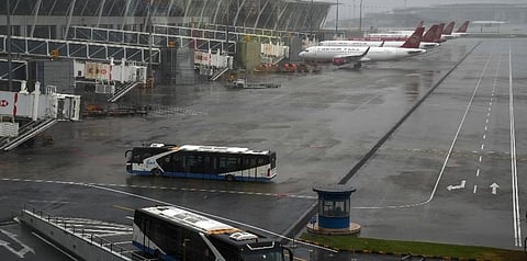 Buses and passenger airplanes are parked on the tarmac after all flights were canceled at Pudong International Airport in Shanghai, China, Sunday, July 25, 2021. (Photo | AP)
