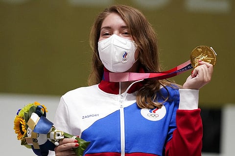 Gold medalist Vitalina Batsarashkina, of the Russian Olympic Committee, holds up her medals after winning the women's 10-meter air pistol event. (Photo | AP)