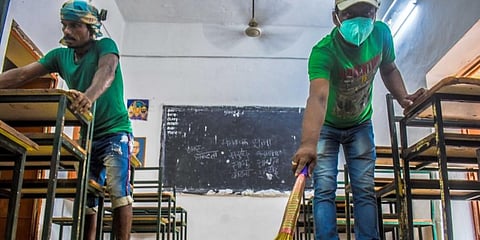 Workers cleaning a classroom in Odisha. (Photo | EPS)