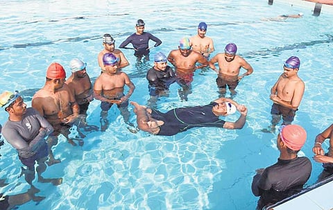 Ashok Baral demonstrating aqua yoga in a swimming pool | Express