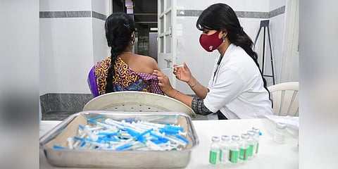 A women getting vaccinated at Dasappa hospital in Bengaluru. (Photo | Ashishkrishna HP, EPS)