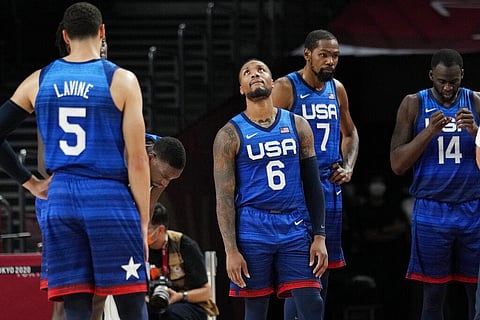 United States' Damian Lillard (6), Kevin Durant (7), and Draymond Green (16) their loss to France in wait for play to resume. (Photo | AP)