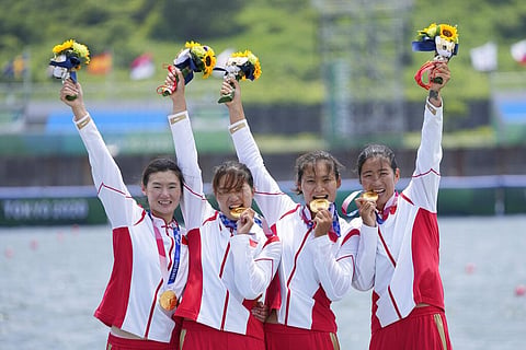 Gold medalists Chen Yunxia, Zhang Ling, Lyu Yang and Cui Xiaotong of China pose for the media during a medal ceremony for the women's rowing quadruple sculls final. (Photo | AP)