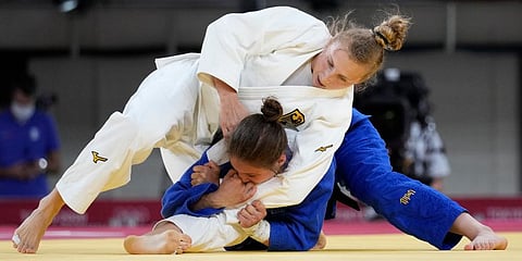 Martyna Trajdos of Germany, top, and Szofi Ozbas of Hungary compete during the women -63kg elimination round of the judo match at the 2020 Summer Olympics in Tokyo, Japan. (Photo | AP)