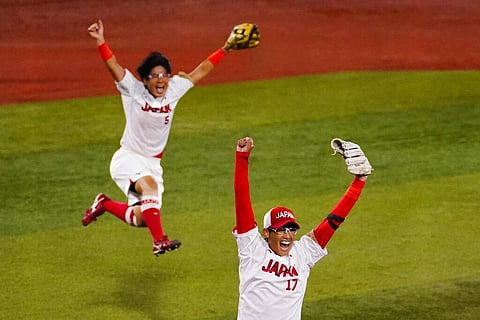 Japan's Yukiko Ueno (17) and Yu Yamamoto (5) celebrates after a softball game against the United States at the 2020 Summer Olympics. (Photo | AP)
