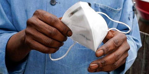 In this Friday, March 5, 2021 file photo, a restaurant worker holds his face mask in Biloxi, Miss. On Friday, March 12, 2021. (File photo | AP)