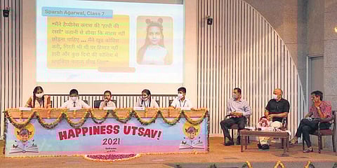 Deputy CM Manish Sisodia and others listen as students share their experiences about Happiness Curriculum in government schools at a function on Friday. (Photo | EPS)