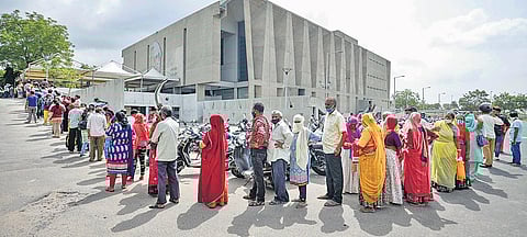 A long wait and queue to take the shot at a vaccination centre operating out of a community hall in Ahmedabad on Friday| PTI
