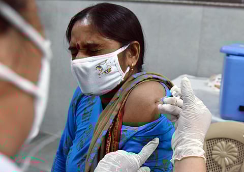 A healthcare worker inoculates a dose of the COVID-19 vaccine to a beneficiary, in New Delhi on Saturday. (Photo | ANI)