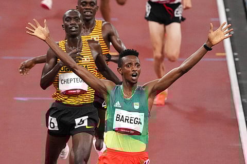 Selemon Barega, of Ethiopia, celebrates after winning the men's 10,000-meter run at the 2020 Summer Olympics, Friday, July 30, 2021, in Tokyo. (Photo | AP)