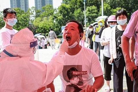 The photo taken on July 30, 2021 shows a man receiving nucleic acid testing for the Covid-19 coronavirus in Huaian, in eastern China's Jiangsu province. (Photo | AFP)