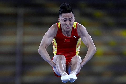 Dong Dong, of China, performs in a men's trampoline gymnastics qualifier at the 2020 Summer Olympics. (Photo | AP)
