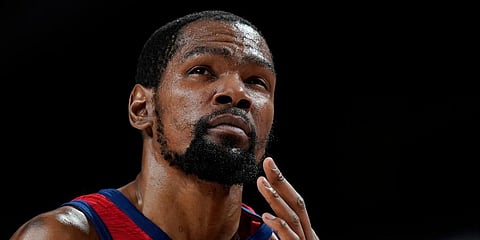 US' Kevin Durant reacts after he collided with another player and hit his face during a men's basketball preliminary round game against the Czech Republic at the 2020 Olympics in Saitama. (Photo | AP)