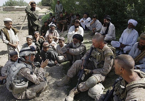 Josh Habib, far left, a 53-year-old translator for the U.S. Marines, speaking with Afghan villagers and two Marines in the Nawa district of Afghanistan's Helmand province. (File Photo | AP)