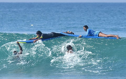 File photo of tourists learning surfing, as surfing activities have resumed at Papanasam beach in Varkala, with the influx of domestic tourists. (Photo | B P Deepu, EPS)