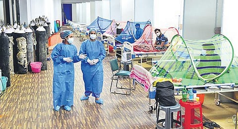 Health workers and patients at a Covid care centre at CWG village in New Delhi | PTI